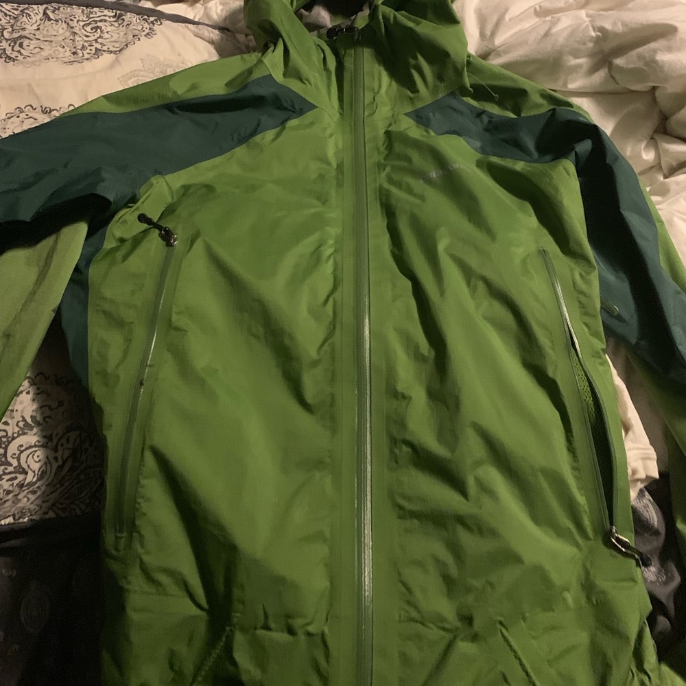 Green Patagonia rain jacket with hood